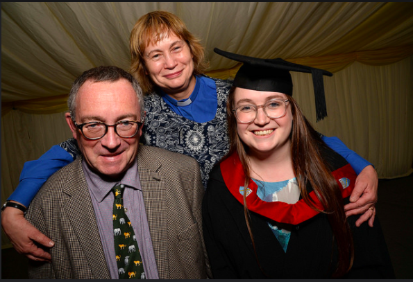 Picture of Ellie at her graduation with her parents.