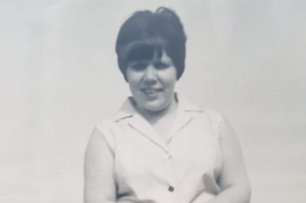 Black and white photograph of Rebeckahs Nan. She has short black hair and is wearing a sleeveless shirt. 