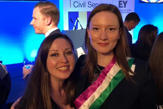 Siobhan Sherry and Victoria Boyes posing at the ceremony. Victoria is wearing a purple, white and green Suffrage sash.