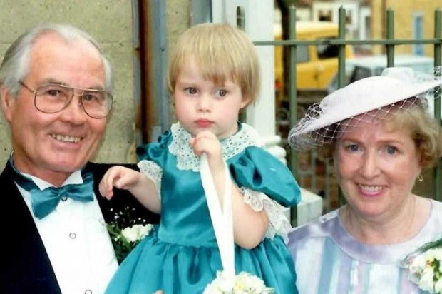 Photograph of a young Siobhan and her grandparents at a wedding. 